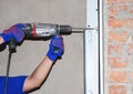 ÃÂ¡onstruction contractor drilling wall for garage door opener installation or repair